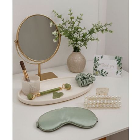 Jade facial roller and gua sha stone in self-care set